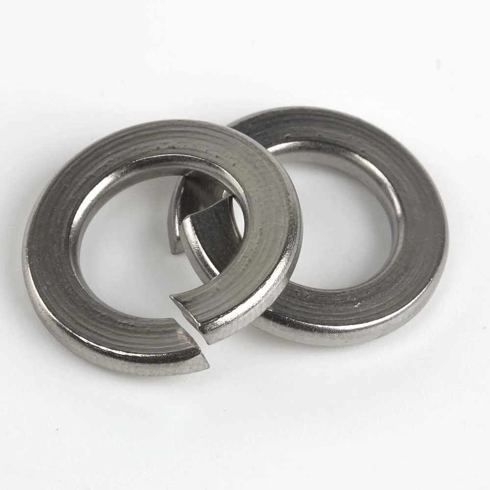 Pair of stainless steel split spring washers viewed at an angle