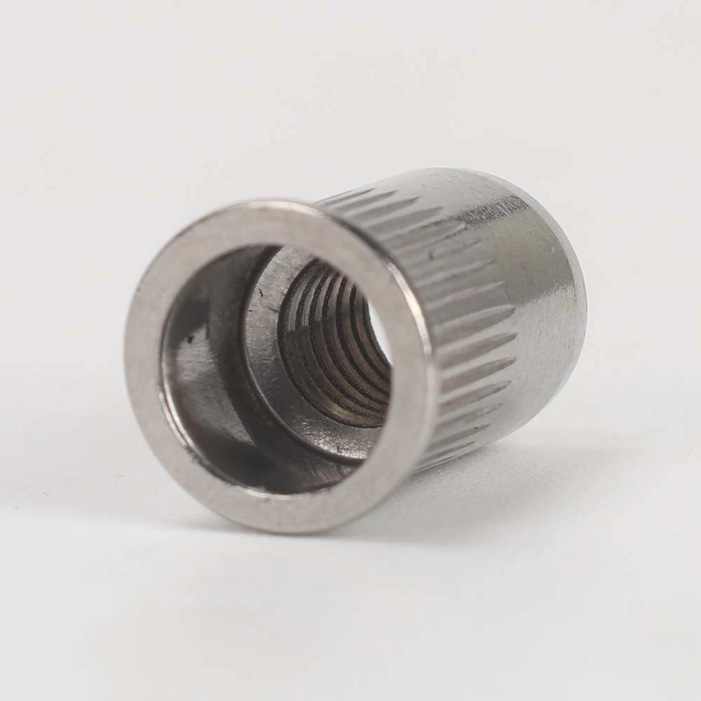 Small countersunk open-end rivet nut with a knurled round body